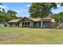 Charming single-story house with a spacious lawn, complemented by mature trees, a modern design, and a cozy, welcoming feel at 3805 Gaines Dr, Winter Haven, FL 33884