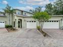 Charming home exterior featuring a brick driveway, two-car garage, and well-manicured landscaping at 3852 Serenade Ln, Lakeland, FL 33811