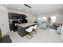 Modern kitchen featuring granite countertops, stainless steel appliances, and an island with seating at 3857 Hampstead Ln, Lakeland, FL 33810