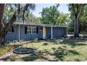 Lovely home with a tree swing, beautiful landscaping, a grey exterior, and an inviting front porch at 3880 Cleveland Heights Blvd, Lakeland, FL 33813