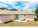 Backyard featuring a concrete patio with outdoor seating and a well-maintained lawn at 3942 Warbler Dr, Winter Haven, FL 33880