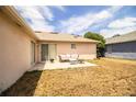 Backyard featuring a cozy patio with outdoor seating, perfect for entertaining at 3942 Warbler Dr, Winter Haven, FL 33880