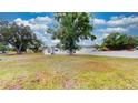Expansive front yard with mature trees surrounding a charming single-story home at 410 Orange St, Bradley, FL 33835