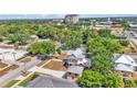Picturesque neighborhood featuring two-story home with a front porch and a detached garage nestled among lush green trees and landscaping at 410 S Broadway Ave, Bartow, FL 33830