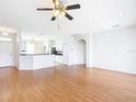 Open-concept living room with hardwood floors flowing into the kitchen, perfect for entertaining at 4219 Windchime Ln, Lakeland, FL 33811