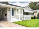 Charming home with gray siding, white trim, manicured lawn, and a welcoming front porch at 422 E Belmar St, Lakeland, FL 33803