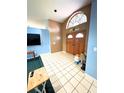 Welcoming foyer features tile flooring, a striking stained-glass window, and wood double-doors at 5218 Parkland Ct, Lakeland, FL 33811