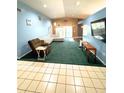 Bright living room with tile entry, plush green carpet, and comfortable seating is ideal for relaxation at 5218 Parkland Ct, Lakeland, FL 33811