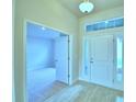 Bright foyer with tile flooring and a view into a carpeted room at 539 Tanaro Ln, Haines City, FL 33844