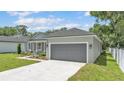 Charming single-story home features a manicured lawn and a welcoming front entrance with decorative columns at 5512 Odom Rd, Lakeland, FL 33809