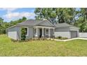Charming single-story home features a manicured lawn and a welcoming front entrance with decorative columns at 5512 Odom Rd, Lakeland, FL 33809