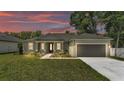 Charming single-story home features a manicured lawn and a welcoming front entrance with decorative columns at 5512 Odom Rd, Lakeland, FL 33809