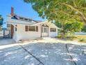 Charming single-story home featuring white siding, brown shutters, a brick chimney, and a well-maintained front yard at 649 Ave J Nw, Winter Haven, FL 33881