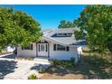 Charming single-story home featuring white siding, brown shutters, a well-maintained yard, and a concrete driveway at 649 Ave J Nw, Winter Haven, FL 33881
