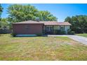 Lovely single-story home featuring a landscaped front yard and cozy facade at 6529 Farris Dr, Lakeland, FL 33811