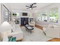 Bright living room with large windows, a cozy fireplace, and neutral decor for comfortable living at 746 Mississippi Ave, Lakeland, FL 33801