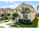 Side view of a well-maintained two-story home with a landscaped yard and driveway, showcasing its charming curb appeal at 8929 Sugar Palm Rd, Kissimmee, FL 34747