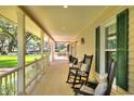 Relaxing front porch with rocking chairs and a view of the spacious front yard at 930 Country Oaks Ln, Lakeland, FL 33810