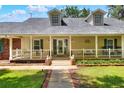 Inviting front porch with white railings, swing, and charming details at 930 Country Oaks Ln, Lakeland, FL 33810