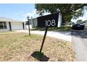 A mailbox with the house number '108' is prominently displayed in front of the property at 108 Sandburg Ln, Winter Haven, FL 33884
