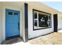 Close-up of a bright blue front door with black trim and a large window at 108 Sandburg Ln, Winter Haven, FL 33884
