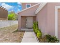 Inviting home front entrance features a covered porch and manicured landscaping at 11 W Bay St, Davenport, FL 33837