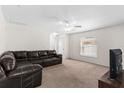 Spacious living room featuring plush carpet, ceiling fan, and plenty of natural light at 11 W Bay St, Davenport, FL 33837