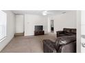 Spacious living room with neutral carpet, and a comfortable leather sofa set at 11 W Bay St, Davenport, FL 33837
