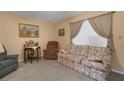A cozy living room with floral sofa, recliner, and natural lighting at 1130 N Lake Parker Ave # C321, Lakeland, FL 33805
