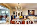 Elegant dining room featuring a classic chandelier, china cabinet and stylish decor at 1195 E George St, Bartow, FL 33830