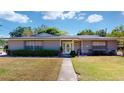Charming home featuring stone accents, a well-manicured lawn, and a welcoming front entrance at 1195 E George St, Bartow, FL 33830