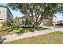 Charming single-Gathering home with a lush green lawn, mature trees, and a well-maintained landscape at 1216 Myopia Hunt Club Dr, Auburndale, FL 33823