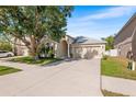 Well-maintained single Gathering home with a large driveway and mature landscaping in a quiet neighborhood at 1216 Myopia Hunt Club Dr, Auburndale, FL 33823