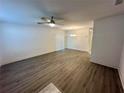 Spacious living room with ceiling fan and wooden floors with bright light at 1253 Dosseywood Ln, Lakeland, FL 33811