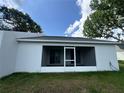 Back porch area that is screened in with a door to the outside at 1253 Dosseywood Ln, Lakeland, FL 33811