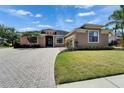 Beautiful front exterior with well-manicured lawn, mature trees and a paved driveway, enhancing curb appeal at 1295 Osprey Landing Dr, Lakeland, FL 33813