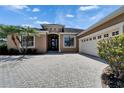 The residence features a two-car garage, providing convenience and ample parking space for homeowners at 1295 Osprey Landing Dr, Lakeland, FL 33813
