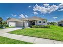 Charming single-story home featuring a two-car garage, stone accents, and beautifully landscaped front yard at 1297 Pintail Pl, Lakeland, FL 33813