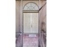 Beige double-door entry with transom window and 'Welcome' mat, seen through an open screen door at 1394 Oakmont Dr, Winter Haven, FL 33884