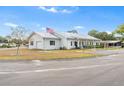 Community clubhouse features a metal roof, American flag, and convenient parking at 145 Jana Cir, Auburndale, FL 33823