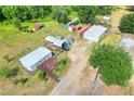 Aerial view showcases the layout of the property and various structures on the property including the home at 14810 Brahma Rd, Polk City, FL 33868