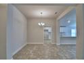 Open dining area with tile flooring, neutral walls, and a view into the bright kitchen at 1517 Leamington Ln, Winter Haven, FL 33884