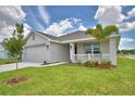 Lovely single-story home with attached garage, a cozy front porch, and well-maintained landscaping at 1517 Leamington Ln, Winter Haven, FL 33884