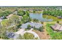 Beautiful aerial view of the home near a serene lake surrounded by lush greenery at 1854 Sherwood Lakes Blvd, Lakeland, FL 33809