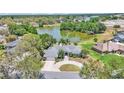 Scenic aerial shot showcasing the home's landscaping and proximity to a tranquil lake at 1854 Sherwood Lakes Blvd, Lakeland, FL 33809