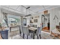 Traditional dining room with stylish gray chairs, decorative wall art, and an abundance of natural light at 1965 Avenue F Sw, Winter Haven, FL 33880