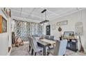 Dining room featuring a large table, comfortable chairs, modern lighting, and decorative accents for Gathering gatherings at 1965 Avenue F Sw, Winter Haven, FL 33880