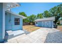 The backyard has a detached garage with white doors, and a spacious, partially grassy area at 202 W Hancock St, Lakeland, FL 33803