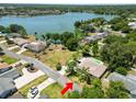 Aerial view of a lakeside home with a pool and lush greenery, showcasing its prime waterfront location at 2103 Sylvester Ct, Lakeland, FL 33803