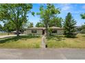 Well-maintained front yard with mature trees enhancing the curb appeal of this charming single-story home at 2103 Sylvester Ct, Lakeland, FL 33803